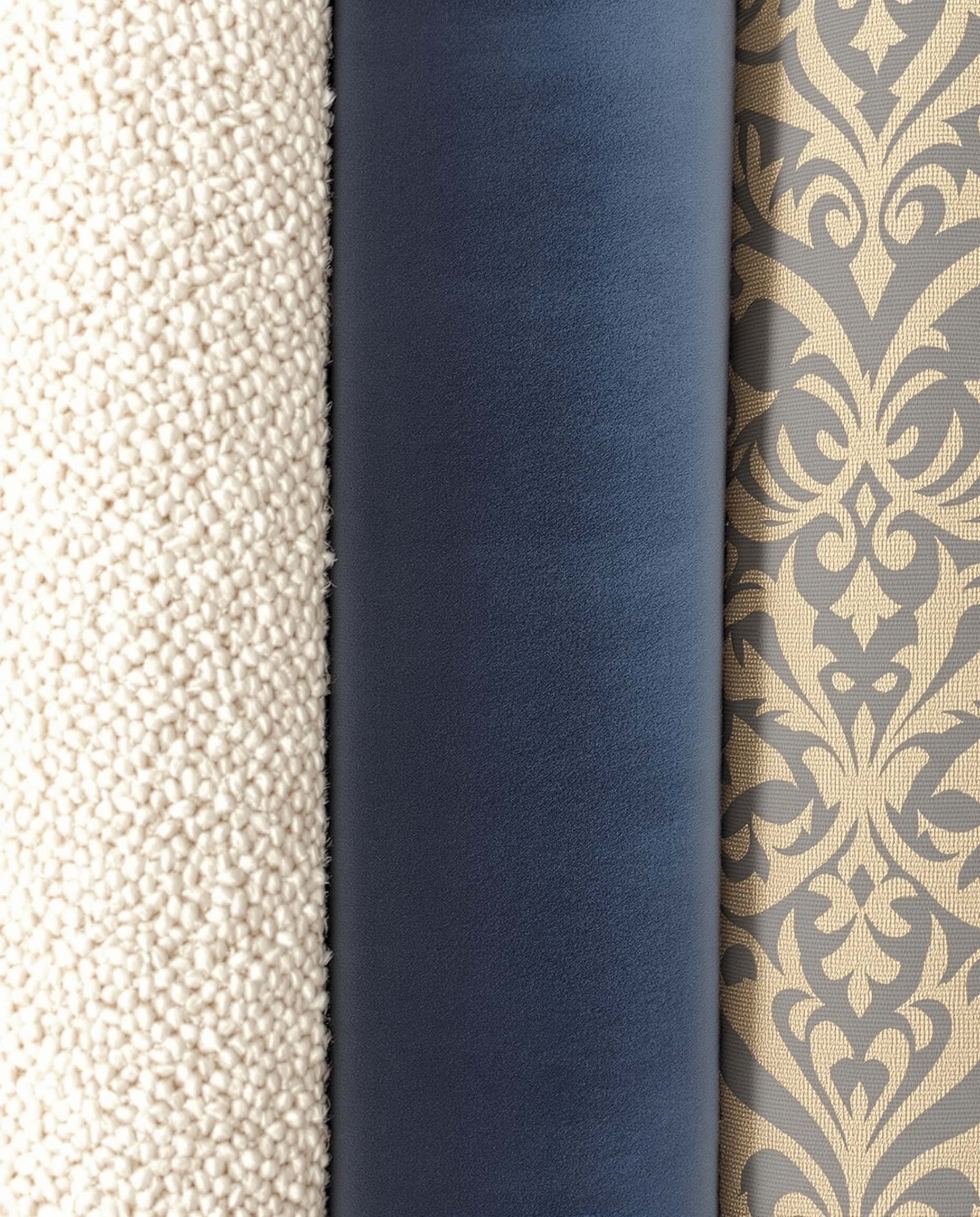 Plan rapproché texturé montrant la richesse des tissus d'ameublement : bouclette crème, velours bleu nuit et jacquard complexe.